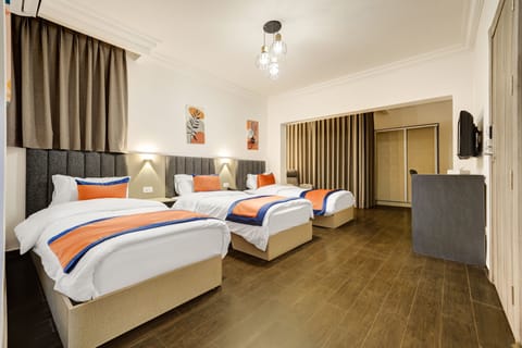 Deluxe Triple Room, City View | In-room safe, desk, soundproofing, free cribs/infant beds