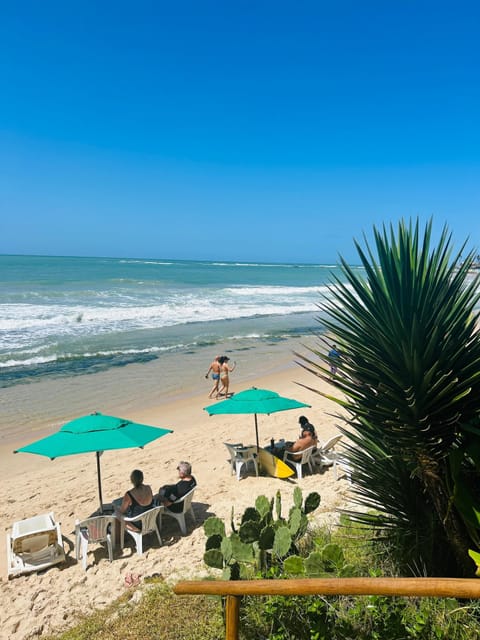 On the beach, white sand, sun loungers, beach umbrellas