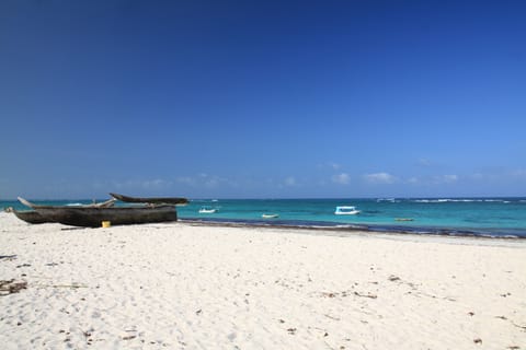 On the beach, white sand, sun loungers, beach umbrellas