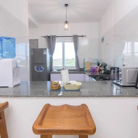 Deluxe Apartment, Balcony, Pool View | Private kitchen | Fridge, microwave, cookware/dishes/utensils, dining tables