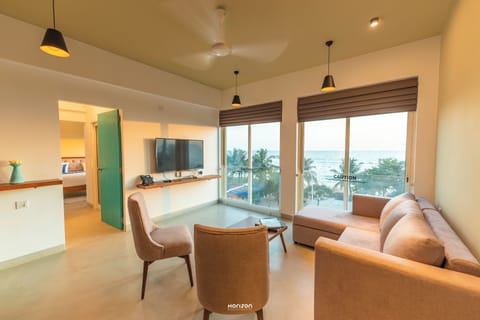 Deluxe Apartment, Sea View | Living area | TV