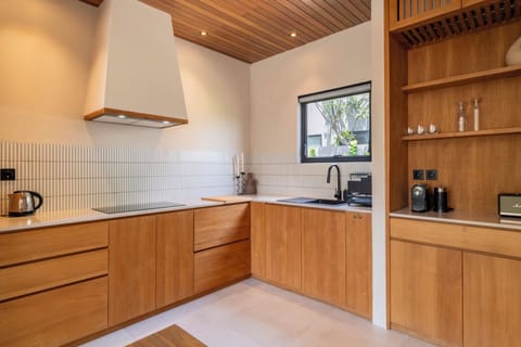 Villa | Private kitchen | Fridge, highchair, dining tables