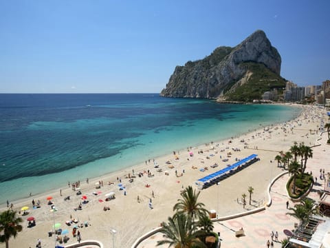 On the beach, white sand, sun loungers, beach umbrellas