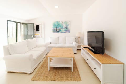 Deluxe Apartment | Living area | 50-inch flat-screen TV with cable channels