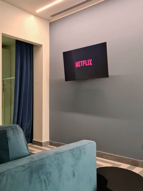 Deluxe Double Room | Living area | 42-inch TV with digital channels