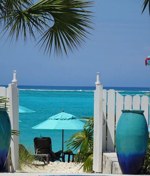 On the beach, white sand, sun loungers, beach umbrellas