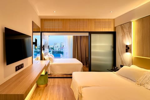 Family Room, Partial Sea View | Premium bedding, minibar, in-room safe, desk