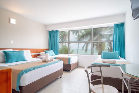 Quadruple Room, Ocean View | Minibar, in-room safe, free cribs/infant beds, bed sheets