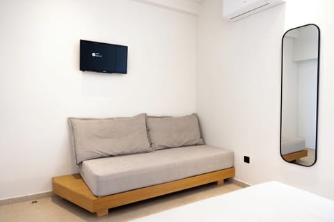 Deluxe Triple Room, Balcony, Sea View | Living area | 32-inch TV with satellite channels