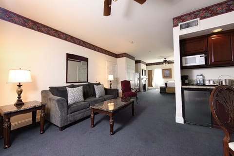 Suite, 1 King Bed with Sofa bed, Balcony, City View | Living area | Fireplace