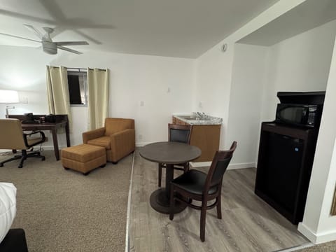 Luxury Suite | Living area | 55-inch Smart TV with cable channels