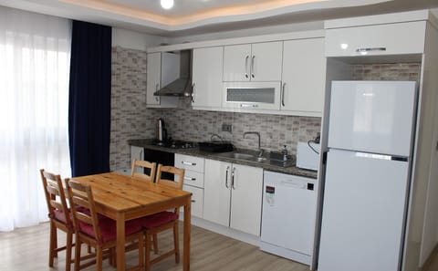 Economy Apartment, Balcony, Garden View | Private kitchen | Microwave, oven, stovetop, highchair