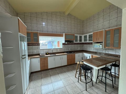 Family House | Private kitchen | Fridge, microwave, cookware/dishes/utensils, dining tables