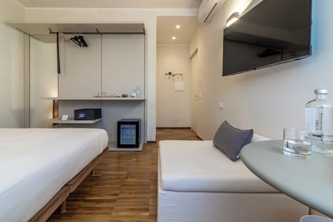 Deluxe Triple Room, City View | In-room safe, desk, laptop workspace, blackout drapes