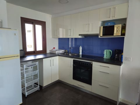 Comfort Apartment, Beachfront | Private kitchen | Full-size fridge, microwave, oven, stovetop