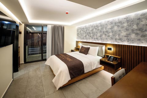 Deluxe Room, Balcony, City View | In-room safe, desk, laptop workspace, blackout drapes