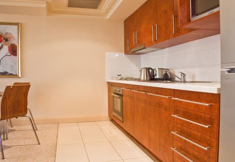 The Executive Riverside Suite | Private kitchen | Full-size fridge, microwave, stovetop, coffee/tea maker