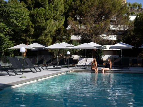 Seasonal outdoor pool, open 9:00 AM to 8:00 PM, pool umbrellas