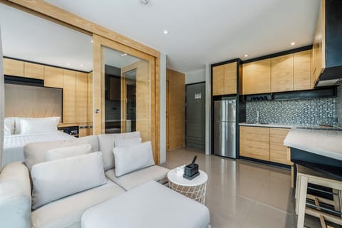 Deluxe Condo, Balcony | Living area | Flat-screen TV