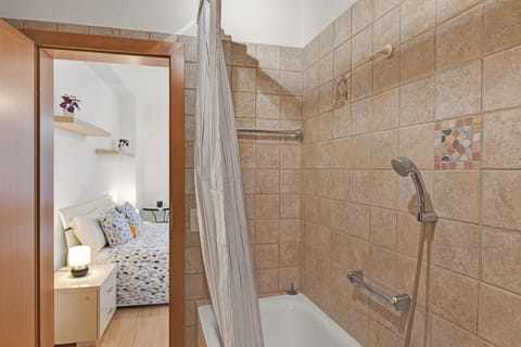 Family Apartment, 1 Bedroom (Lugano Bay View Uno) | Bathroom | Combined shower/tub, hair dryer, towels, soap