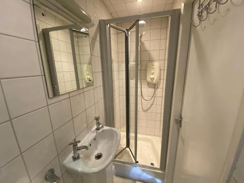 Shower, hair dryer, towels, toilet paper