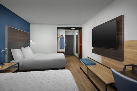 Premium bedding, desk, laptop workspace, blackout drapes