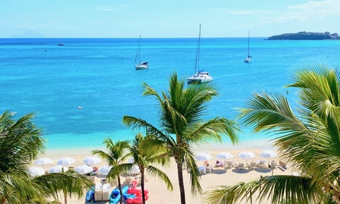 On the beach, white sand, sun loungers, beach umbrellas