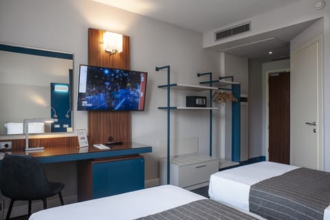 Executive Triple Room | In-room safe, individually decorated, desk, blackout drapes