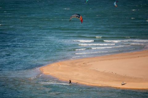 On the beach, white sand, sun loungers, beach towels