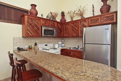 Deluxe Apartment, 2 Bedrooms, Pool View | Private kitchen | Full-size fridge, microwave, stovetop, dishwasher