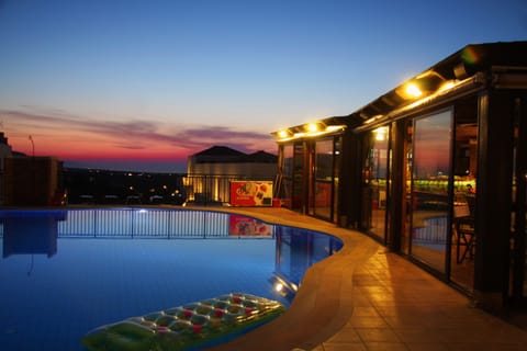 Outdoor pool, a rooftop pool, pool umbrellas, sun loungers