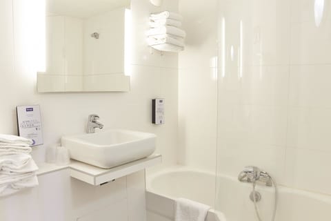 Combined shower/tub, eco-friendly toiletries, hair dryer, slippers