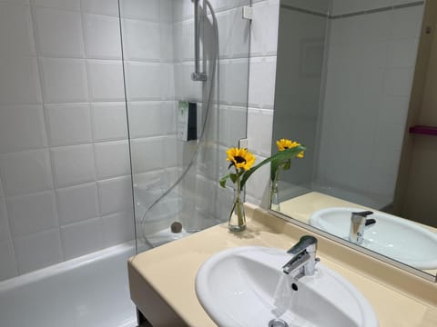 Bathtub, eco-friendly toiletries, hair dryer, towels