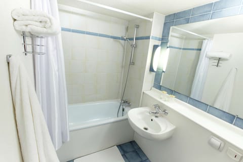 Bathtub, eco-friendly toiletries, hair dryer, towels