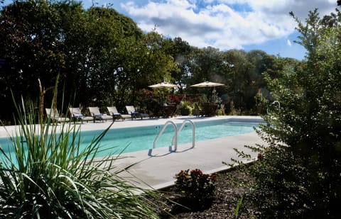 Seasonal outdoor pool, open 9:00 AM to 7:00 PM, pool umbrellas