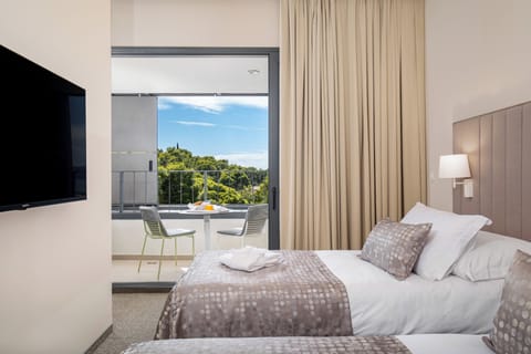 Deluxe Double or Twin Room, Balcony, Sea View | Minibar, in-room safe, desk, blackout drapes