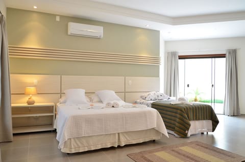 Luxury Triple Room, Jetted Tub, Ground Floor | Minibar, individually decorated, individually furnished