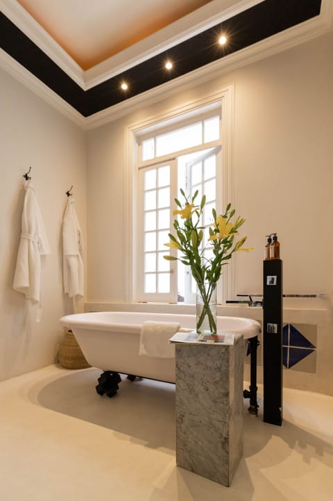 Gravity Suite | Bathroom | Separate tub and shower, rainfall showerhead, designer toiletries