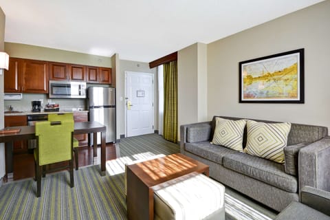 Suite, 2 Queen Beds | Living area | 27-inch TV with cable channels, MP3 dock