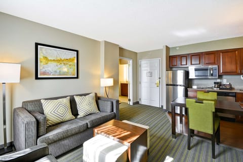 Suite, 2 Bedrooms | Living area | 27-inch TV with cable channels, MP3 dock