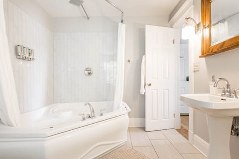 King Bed Jetted Tub (Clara and Russell Stover) | Bathroom | Hair dryer, bathrobes, towels, soap