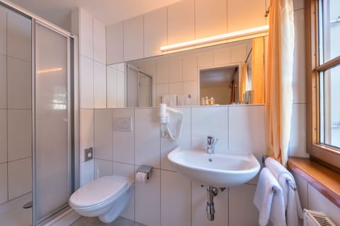 Shower, hair dryer, towels, toilet paper