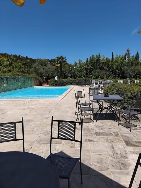 Seasonal outdoor pool, open 8:00 AM to 8:00 PM, pool umbrellas