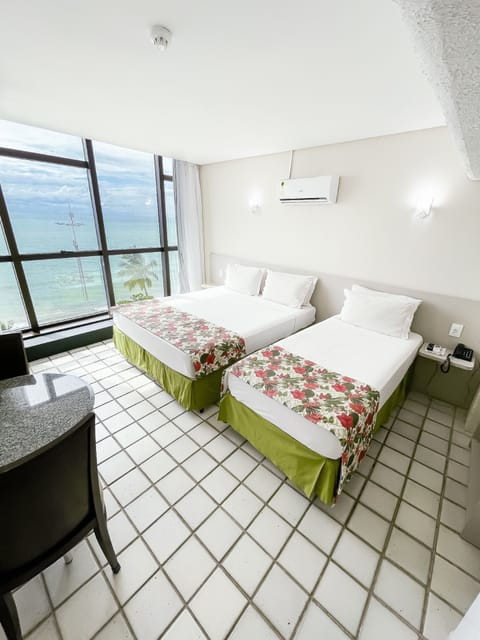 Executive Triple Room, Sea View | Minibar, in-room safe, blackout drapes, free cribs/infant beds