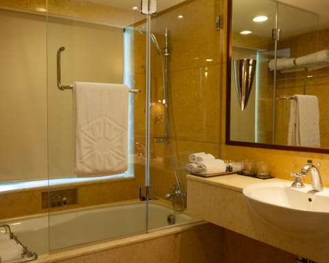 Deluxe Room, 1 King Bed | Bathroom | Hair dryer, slippers, towels