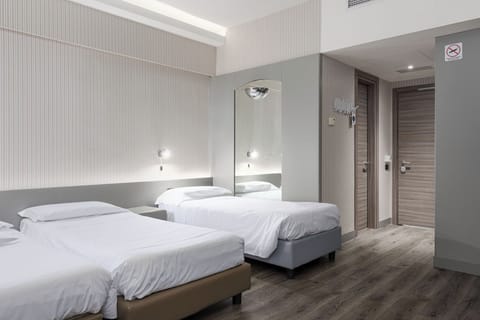 Standard Quadruple Room | Minibar, in-room safe, desk, laptop workspace