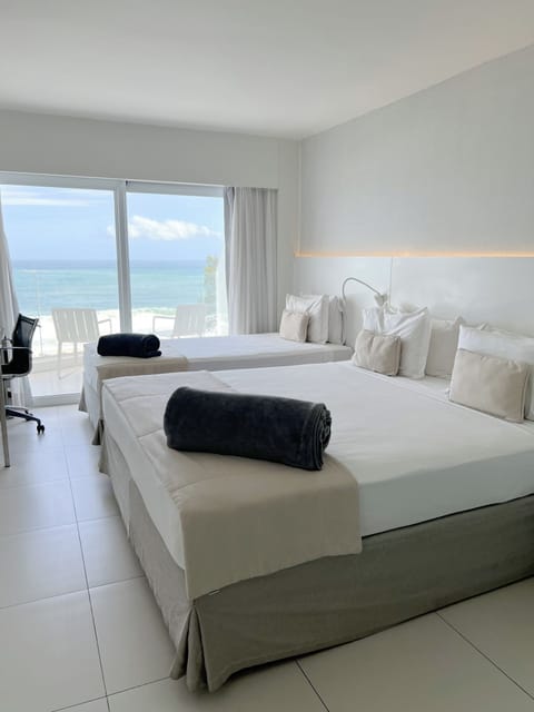 Premier Triple Room, Patio, Sea View | Hypo-allergenic bedding, minibar, in-room safe, desk