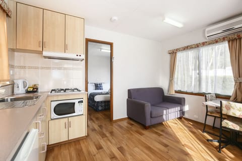 Standard 1 Bedroom Cabin | Living area | Flat-screen TV