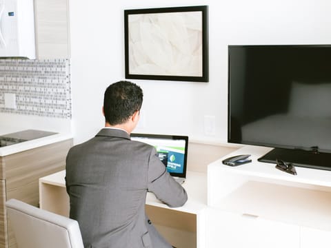 Desk, laptop workspace, blackout drapes, iron/ironing board