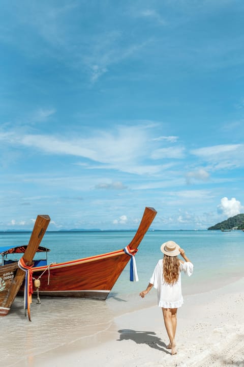 On the beach, white sand, beach umbrellas, beach towels